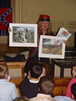 Which is the Confederate mascot?  Which is the Union Mascot?  Stonewall on the left, is the Confederate mascot.  The Confederate soldiers in gray uniforms are holding a Confederate flag.  Sallie, the Union mascot,  is on the right. The Union soldiers have blue uniforms and are carrying the United States Union flag. (59kb)